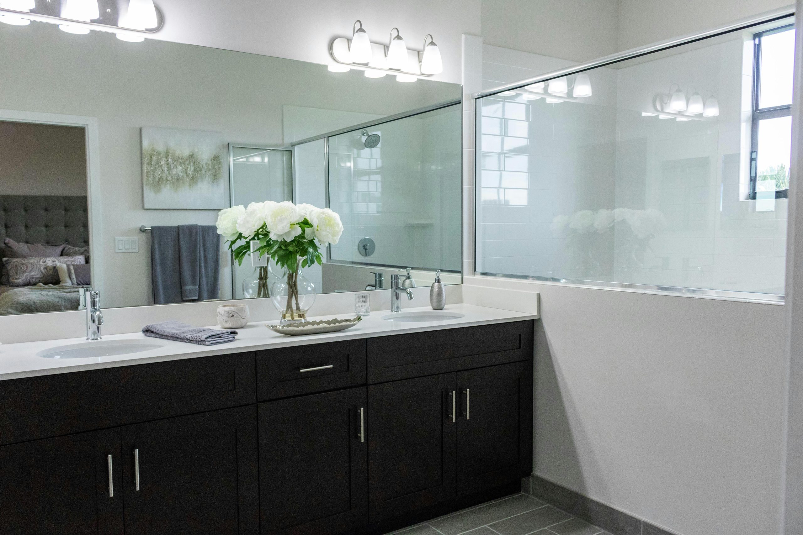 Bright and elegant bathroom featuring dual sinks and contemporary decor.